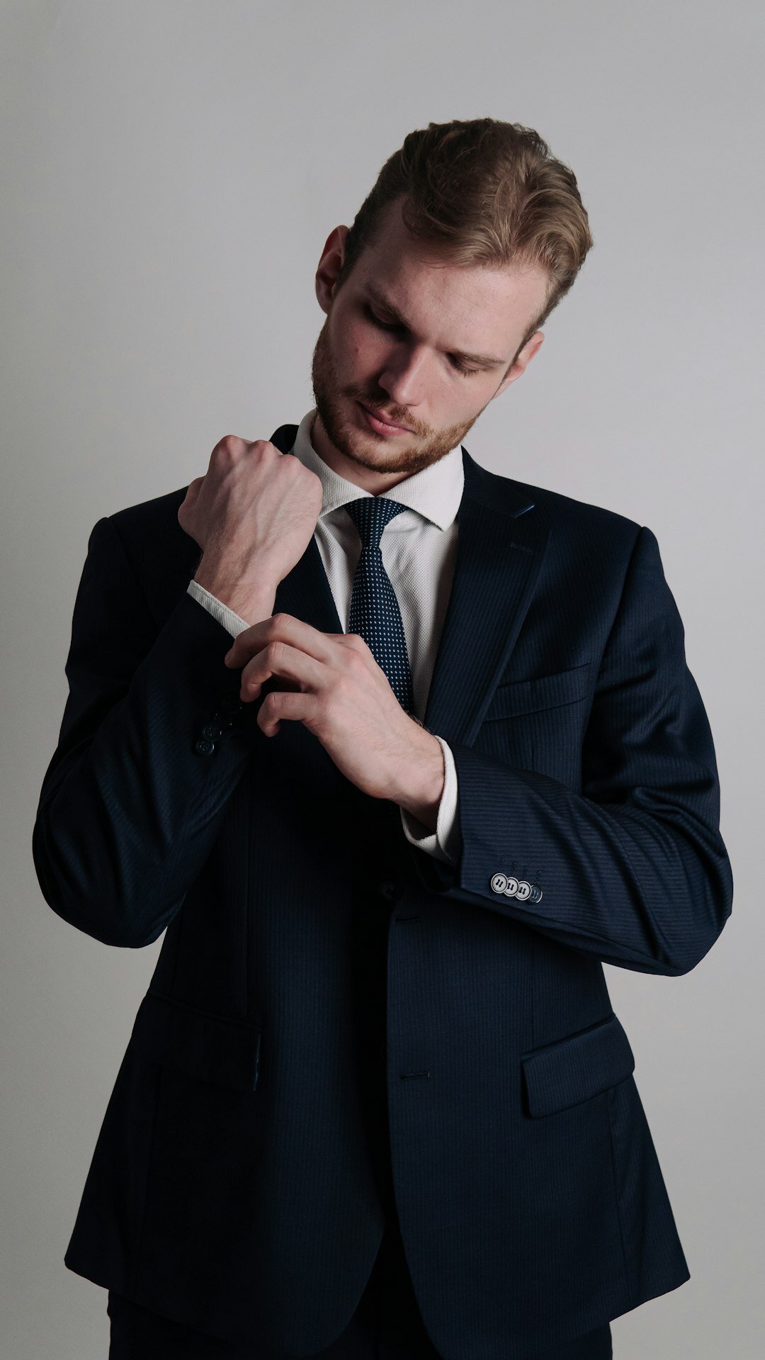 Studio portrait of a European businessman in a navy suit