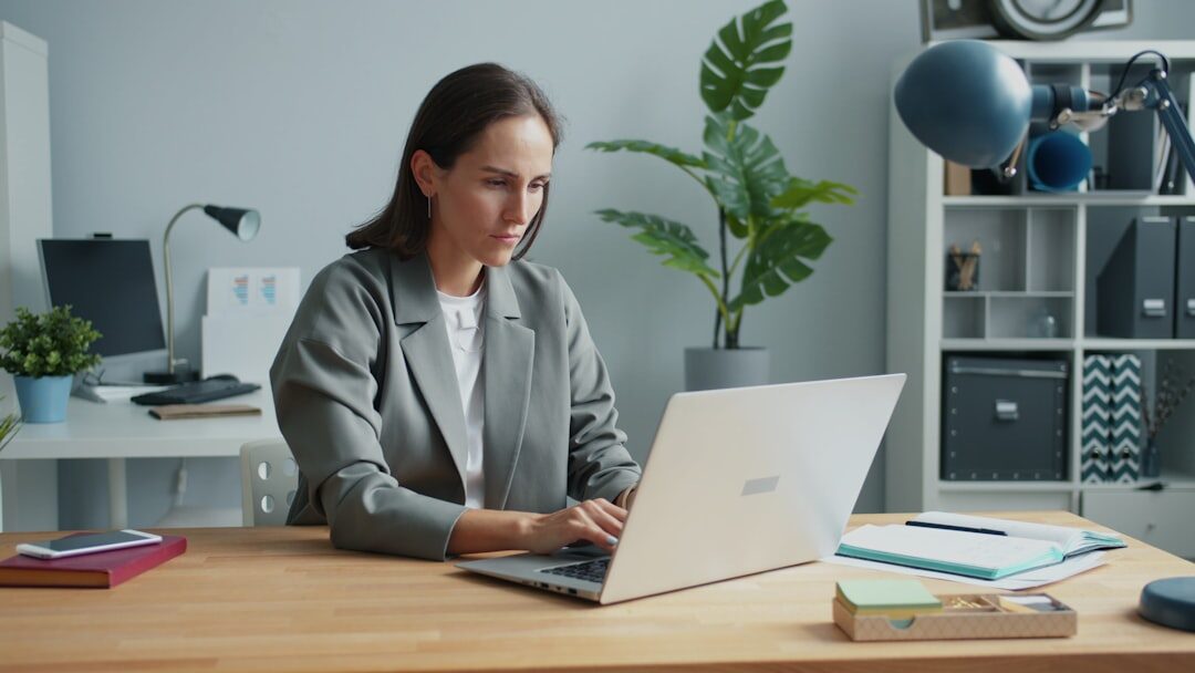 Businesswoman focused while working on a laptop at a desk