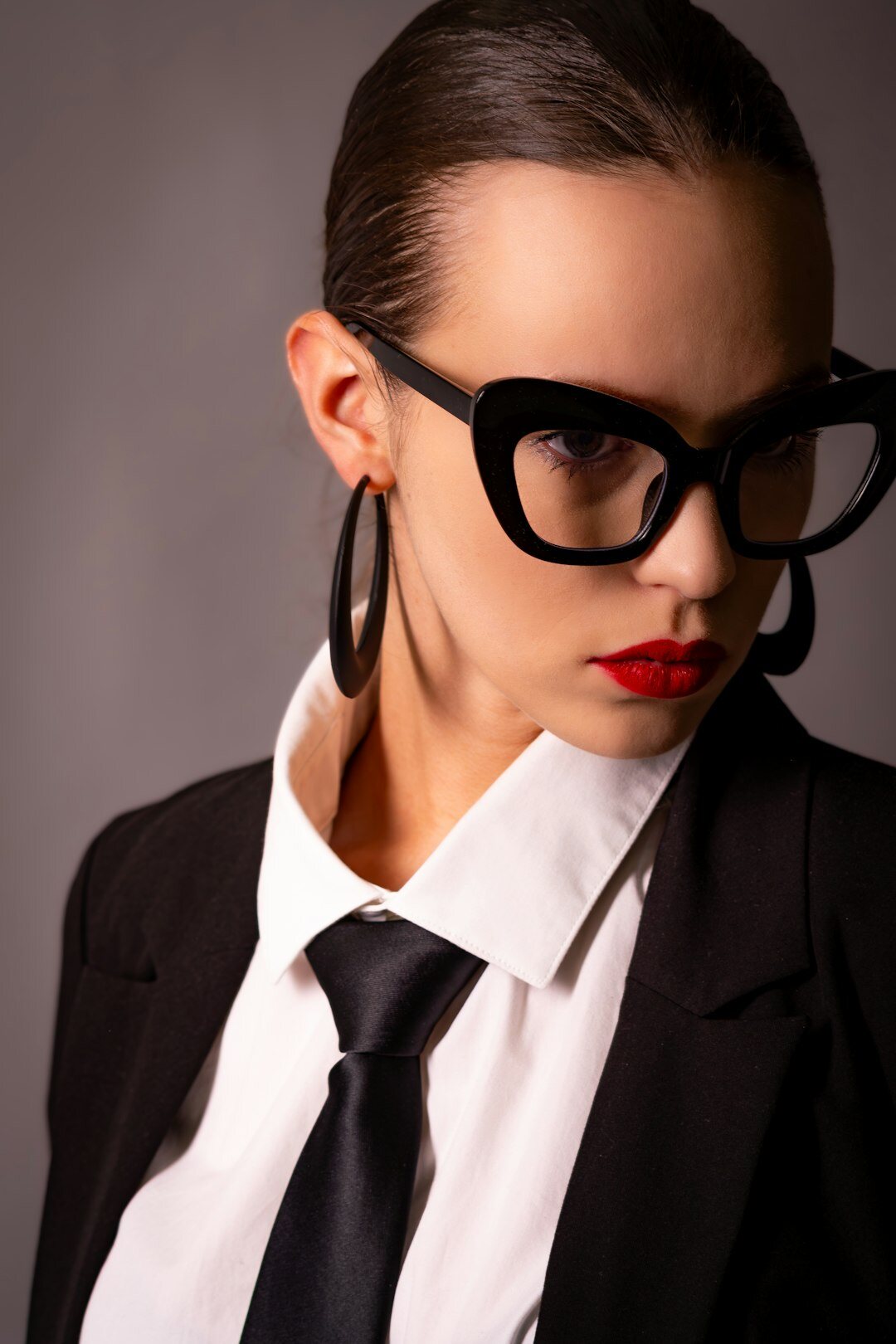 Studio portrait of a confident European businesswoman with glasses